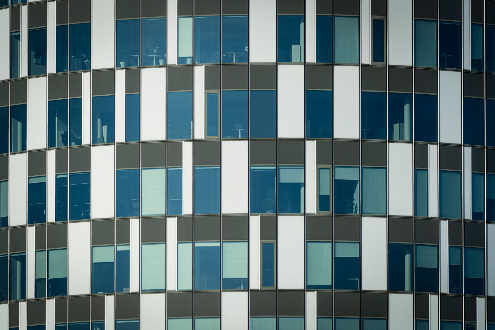 Geometric glass office facade in a modern city.